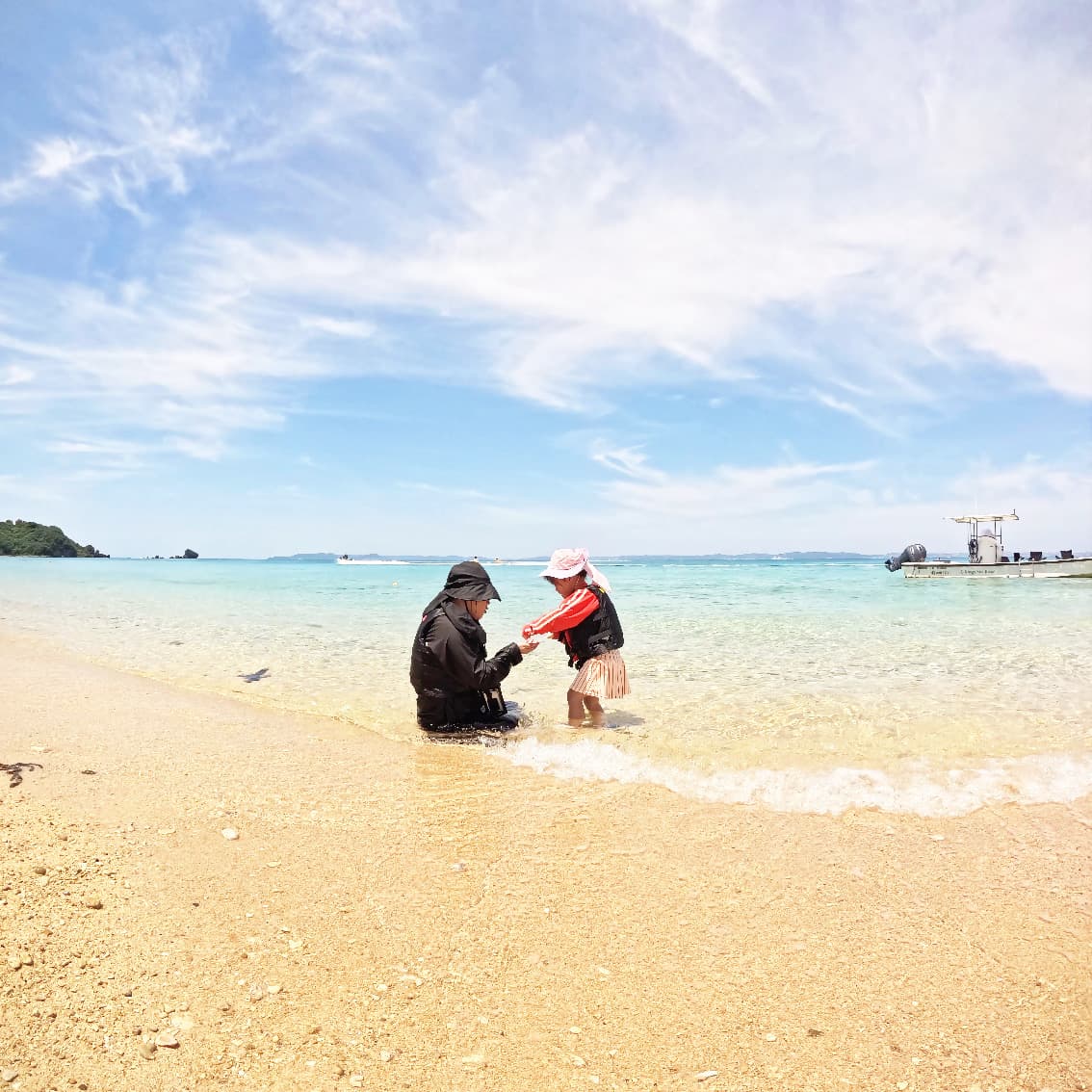 Parent and child playing at the water's edge