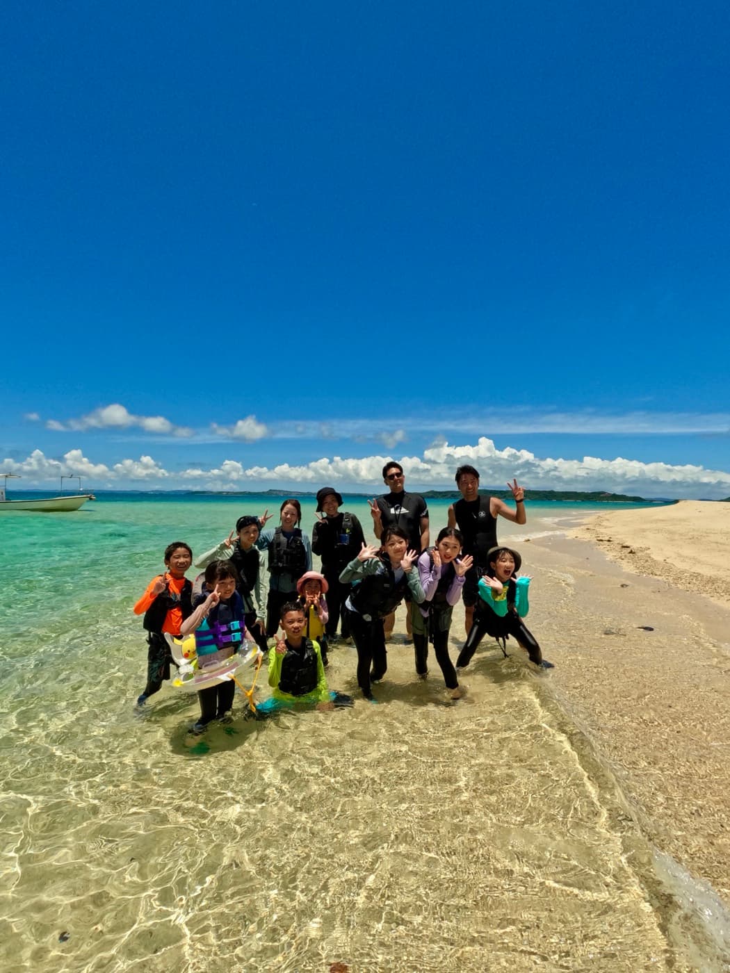 Tour guests together on an uninhabited island sandbar