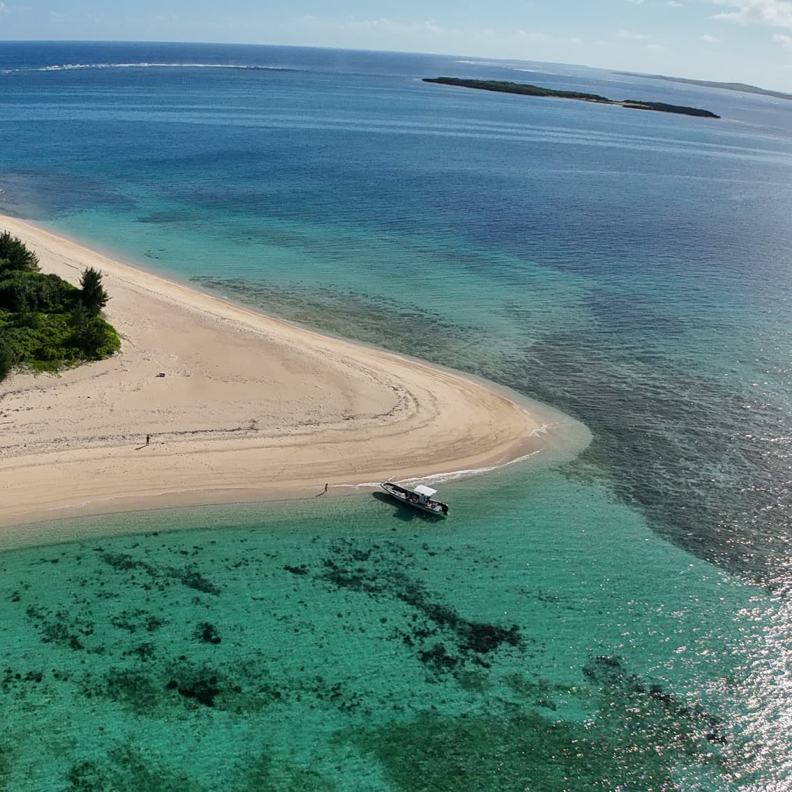 Aerial view of the private boat moored at an uninhabited island sandbar