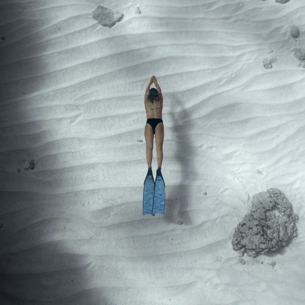Diving straight down over white sand ripples